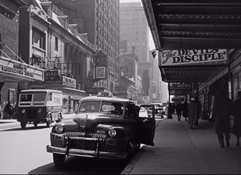Movie still from “All About Eve” (1950), directed by Joseph L. Mankiewicz – An old black and white photo of a car parked on the side of the street; Extreme Wide shot, High angle