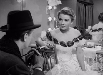 A man and a woman are sitting in front of a mirror