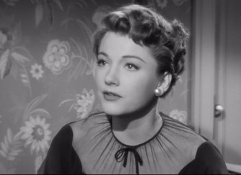 Movie still from “All About Eve” (1950), directed by Joseph L. Mankiewicz – A black - and - white photo of a woman in a black dress; Close Up shot, Low angle