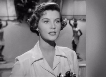 Movie still from “All About Eve” (1950), directed by Joseph L. Mankiewicz – A black - and - white photo of a woman in a white shirt; Close Up shot, Low angle