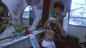 Movie still from “All About Lily Chou-Chou” (2001), directed by Shunji Iwai – A woman getting her hair done in a salon; Medium shot, High angle