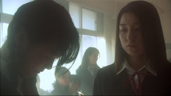 Movie still from “All About Lily Chou-Chou” (2001), directed by Shunji Iwai – A group of people standing in front of a window; Close Up shot, Low angle