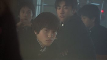 Movie still from “All About Lily Chou-Chou” (2001), directed by Shunji Iwai – A group of young people standing next to each other; Close Up shot, Low angle
