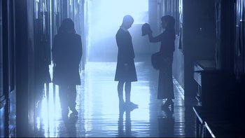 Movie still from “All About Lily Chou-Chou” (2001), directed by Shunji Iwai – A group of people standing in a hallway; Wide shot, Low angle