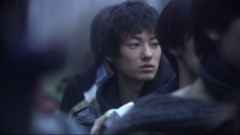 Movie still from “All About Lily Chou-Chou” (2001), directed by Shunji Iwai – A young man is looking into the distance while sitting on a bus; Close Up shot, Low angle