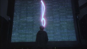 Movie still from “All About Lily Chou-Chou” (2001), directed by Shunji Iwai – A man standing in front of a large screen with a lightning strike in it; Wide shot, Low angle
