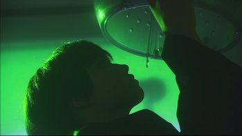 Movie still from “All About Lily Chou-Chou” (2001), directed by Shunji Iwai – A person is looking into a mirror in a room; Close Up shot, Low angle