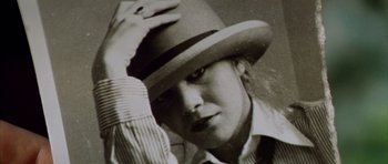 Movie still from “All About My Mother” (1999), directed by Pedro Almodóvar – A black and white photo of a man wearing a hat; Close Up shot, Low angle