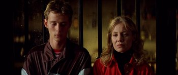 Movie still from “All About My Mother” (1999), directed by Pedro Almodóvar – A man and a woman sitting next to each other; Close Up shot, Low angle