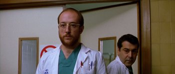Movie still from “All About My Mother” (1999), directed by Pedro Almodóvar – A man in a white lab coat standing next to another man in a white lab coat; Close Up shot, Low angle