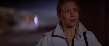 Movie still from “All About My Mother” (1999), directed by Pedro Almodóvar – A person wearing a white shirt; Close Up shot, Over the shoulder angle