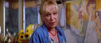 Movie still from “All About My Mother” (1999), directed by Pedro Almodóvar – A person wearing a blue shirt; Close Up shot, Low angle