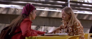 Movie still from “All About My Mother” (1999), directed by Pedro Almodóvar – Two women sitting at a table talking to each other; Medium shot, High angle
