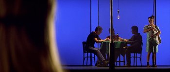 Movie still from “All About My Mother” (1999), directed by Pedro Almodóvar – A man and woman sitting at a dinner table; Wide shot, Low angle
