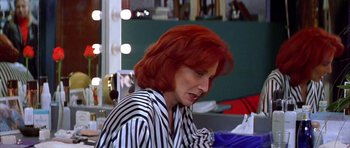 Movie still from “All About My Mother” (1999), directed by Pedro Almodóvar – A woman with red hair sitting in front of a mirror; Close Up shot, High angle