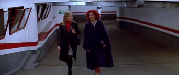 Movie still from “All About My Mother” (1999), directed by Pedro Almodóvar – Two women walking down a hallway in a building; Medium shot, Low angle