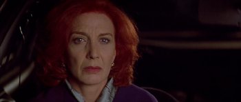 Movie still from “All About My Mother” (1999), directed by Pedro Almodóvar – A person with red hair; Close Up shot, Low angle
