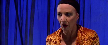 Movie still from “All About My Mother” (1999), directed by Pedro Almodóvar – A woman with a black head band is looking at the camera; Close Up shot, Low angle