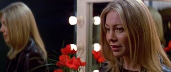 Movie still from “All About My Mother” (1999), directed by Pedro Almodóvar – A person sitting in front of a mirror; Close Up shot, Over the shoulder angle