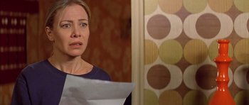 Movie still from “All About My Mother” (1999), directed by Pedro Almodóvar – A woman holding a piece of paper in front of her face; Close Up shot, Over the shoulder angle
