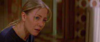 Movie still from “All About My Mother” (1999), directed by Pedro Almodóvar – A person with long blonde hair; Close Up shot, Over the shoulder angle