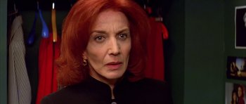 Movie still from “All About My Mother” (1999), directed by Pedro Almodóvar – A person with red hair; Close Up shot, Low angle