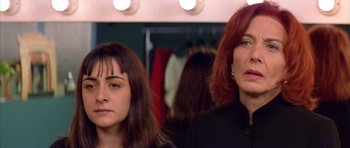 Movie still from “All About My Mother” (1999), directed by Pedro Almodóvar – Two women standing in front of a dressing room mirror; Close Up shot, Low angle