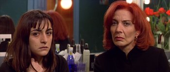 Movie still from “All About My Mother” (1999), directed by Pedro Almodóvar – Two women sitting at a table in front of each other; Close Up shot, Over the shoulder angle