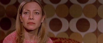 Movie still from “All About My Mother” (1999), directed by Pedro Almodóvar – A person sitting on a couch; Close Up shot, High angle