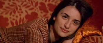 Movie still from “All About My Mother” (1999), directed by Pedro Almodóvar – A person sitting on a couch; Close Up shot, High angle