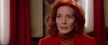 Movie still from “All About My Mother” (1999), directed by Pedro Almodóvar – A person wearing a suit and tie; Close Up shot, Low angle