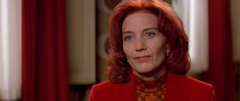 Movie still from “All About My Mother” (1999), directed by Pedro Almodóvar – A person wearing a suit and tie; Close Up shot, Low angle