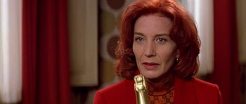 Movie still from “All About My Mother” (1999), directed by Pedro Almodóvar – A woman with red hair holding an award in her hand; Close Up shot, Low angle