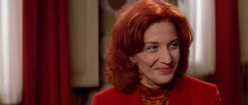 Movie still from “All About My Mother” (1999), directed by Pedro Almodóvar – A person wearing a red jacket; Close Up shot, Over the shoulder angle