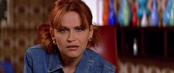 Movie still from “All About My Mother” (1999), directed by Pedro Almodóvar – A person wearing a jean jacket; Close Up shot, Over the shoulder angle
