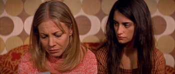 Movie still from “All About My Mother” (1999), directed by Pedro Almodóvar – Two women sitting next to each other in a room; Close Up shot, High angle