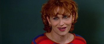 Movie still from “All About My Mother” (1999), directed by Pedro Almodóvar – A person with red hair; Close Up shot, Over the shoulder angle