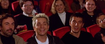 Movie still from “All About My Mother” (1999), directed by Pedro Almodóvar – A group of people sitting in a movie theater; Close Up shot, Low angle