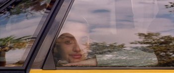 Movie still from “All About My Mother” (1999), directed by Pedro Almodóvar – A woman looking out of the window of a car; Close Up shot, Low angle