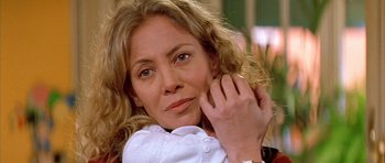 Movie still from “All About My Mother” (1999), directed by Pedro Almodóvar – A person sitting on a couch; Close Up shot, Low angle