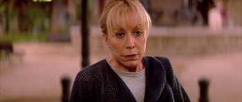 Movie still from “All About My Mother” (1999), directed by Pedro Almodóvar – An older woman with blonde hair wearing a gray sweater; Close Up shot, High angle