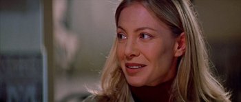 Movie still from “All About My Mother” (1999), directed by Pedro Almodóvar – A person with long blonde hair; Close Up shot, Over the shoulder angle