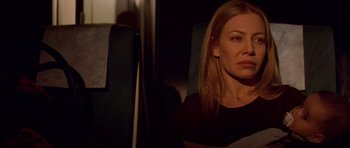 Movie still from “All About My Mother” (1999), directed by Pedro Almodóvar – A woman sitting on a train looking into the distance; Close Up shot, Over the shoulder angle