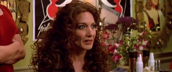 Movie still from “All About My Mother” (1999), directed by Pedro Almodóvar – A person with curly hair; Close Up shot, Over the shoulder angle