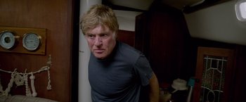 Movie still from “All Is Lost” (2013), directed by J.C. Chandor – A person wearing a t - shirt; Close Up shot, Low angle