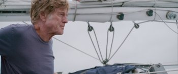 Movie still from “All Is Lost” (2013), directed by J.C. Chandor – An older man standing next to a sailboat in the water; Close Up shot, Low angle