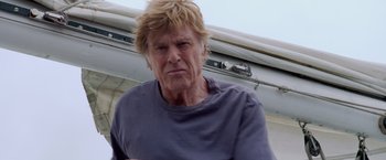 Movie still from “All Is Lost” (2013), directed by J.C. Chandor – An older man with blonde hair and a blue shirt; Close Up shot, Low angle