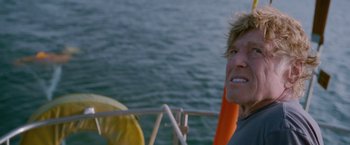 Movie still from “All Is Lost” (2013), directed by J.C. Chandor – A person on a sailboat in the water; Close Up shot, Low angle