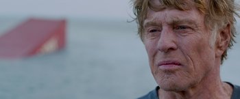 Movie still from “All Is Lost” (2013), directed by J.C. Chandor – A man's face in front of the ocean; Close Up shot, Over the shoulder angle