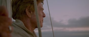 Movie still from “All Is Lost” (2013), directed by J.C. Chandor – An older man looking out at the sky from a sailboat; Close Up shot, Low angle